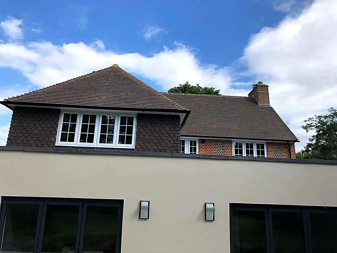 The same Surrey house from the side, showing the tiled roof and the roofline