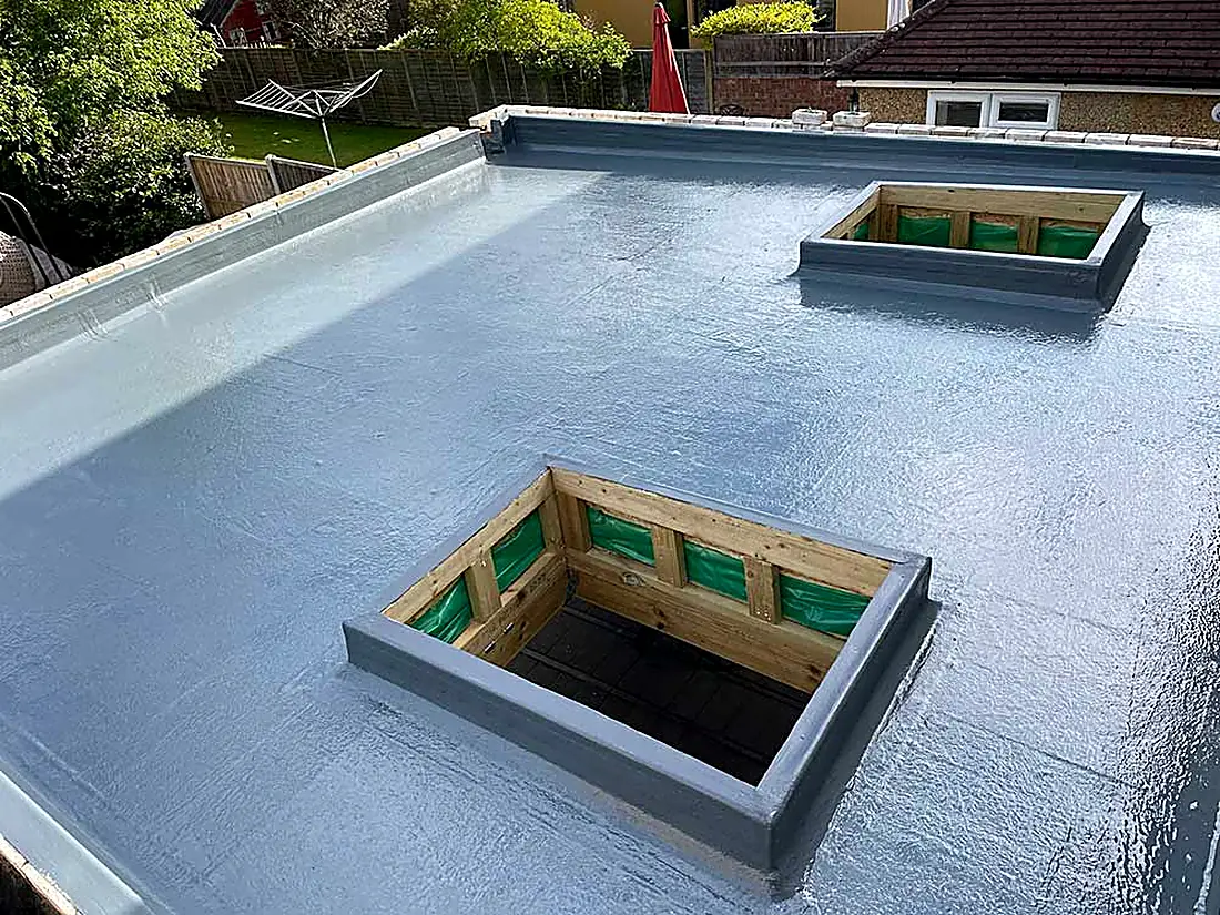 A fibreglass flat roof with two rooflight upstands ready for glazing