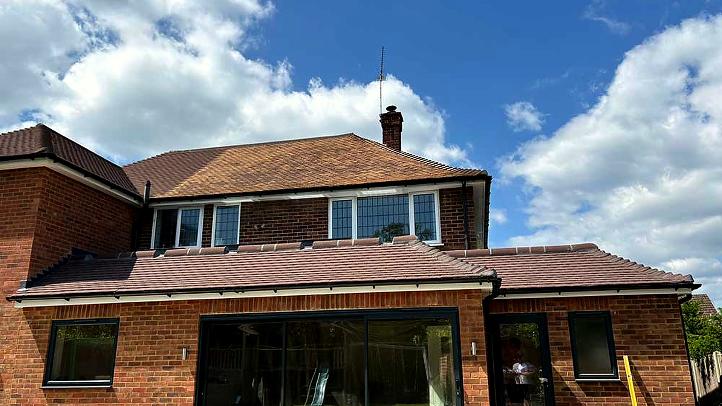 A Surrey house with a newly finished tiled roof and single-storey rear extension by GB Roofing Services