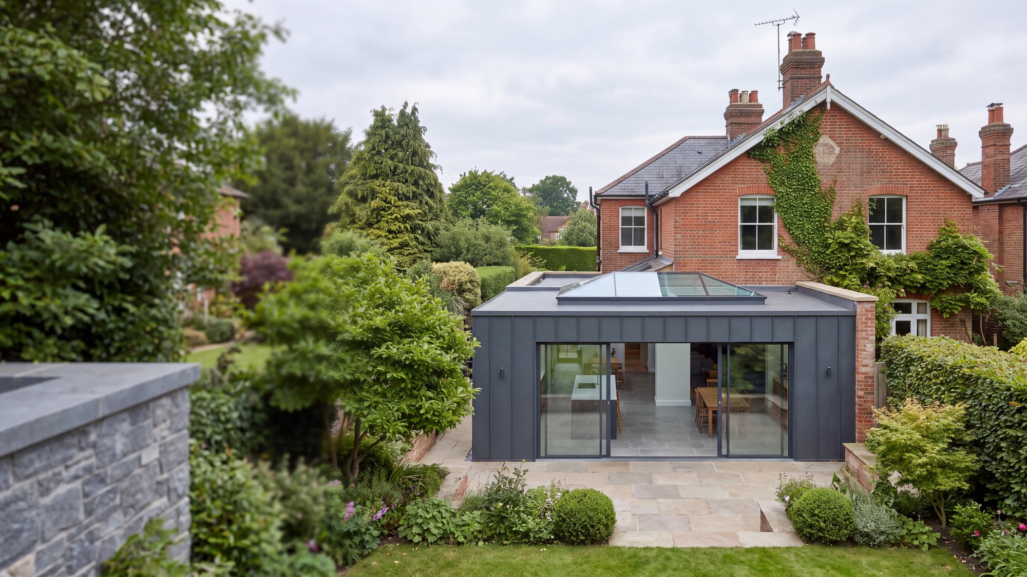 A modern rear extension with a flat roof and a large flush glass rooflight