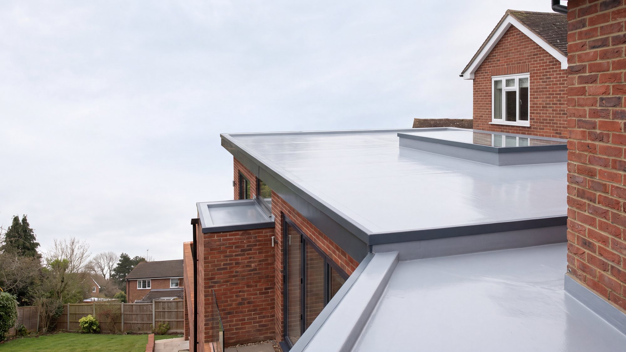 A smooth GRP fibreglass flat roof with a neat trim edge and no joints or seams