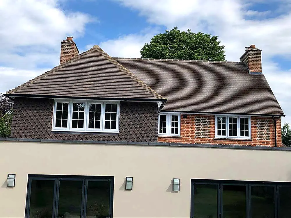 A Surrey house with a completed brown tiled roof