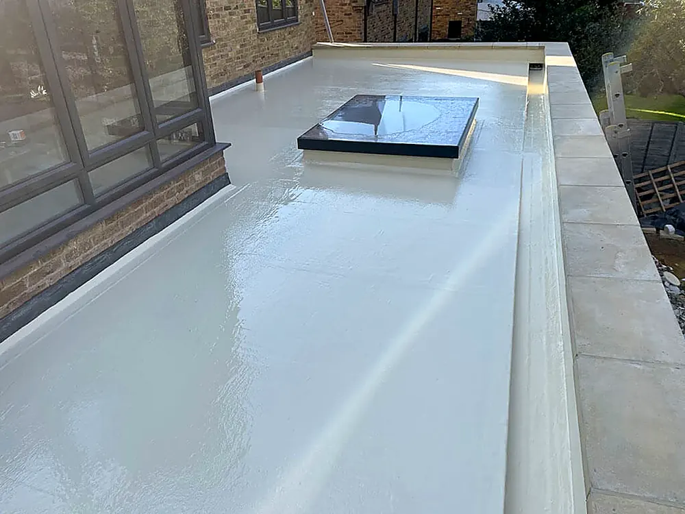 A fibreglass flat roof finished neatly around a rooflight upstand